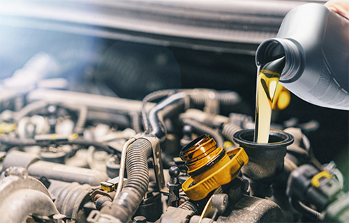 Oil is poured into a filter during oil change service in Pompano Beach