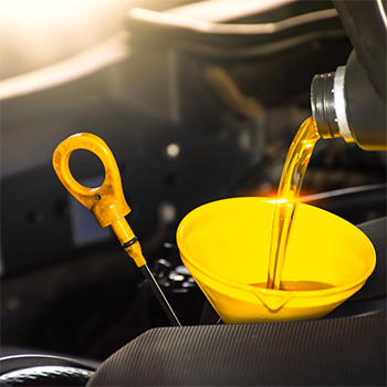 Oil measuring stick is in place with funnel during oil changes at Pompano Beach