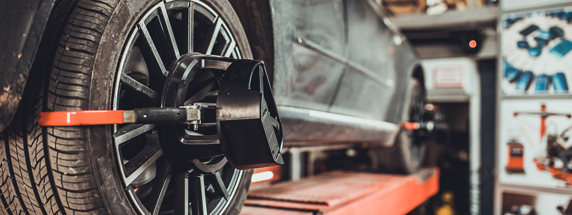 Tire being aligned during wheel alignment service