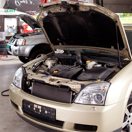 Car with open hood undergoing auto maintenance and auto repair in Pompano Beach